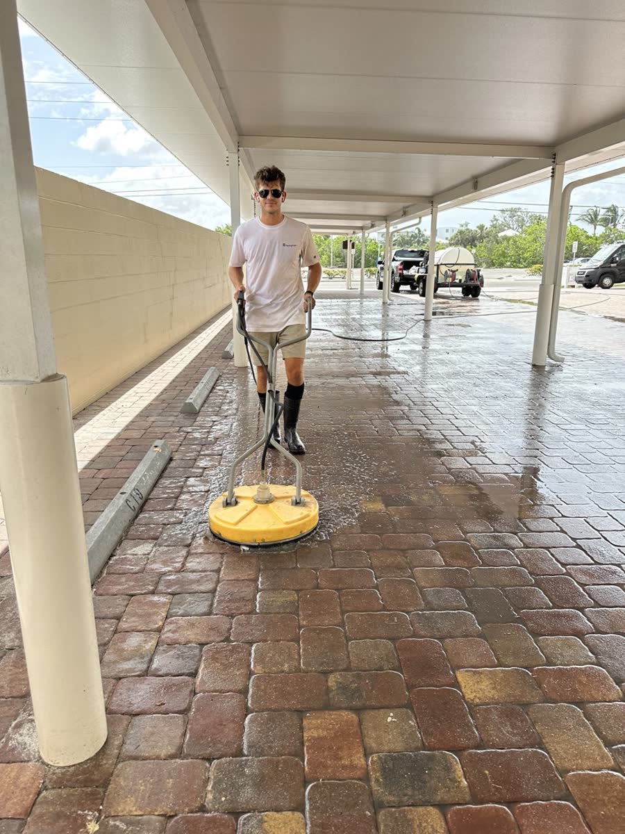 KB Sealing crew surface-cleaning a paver lanai