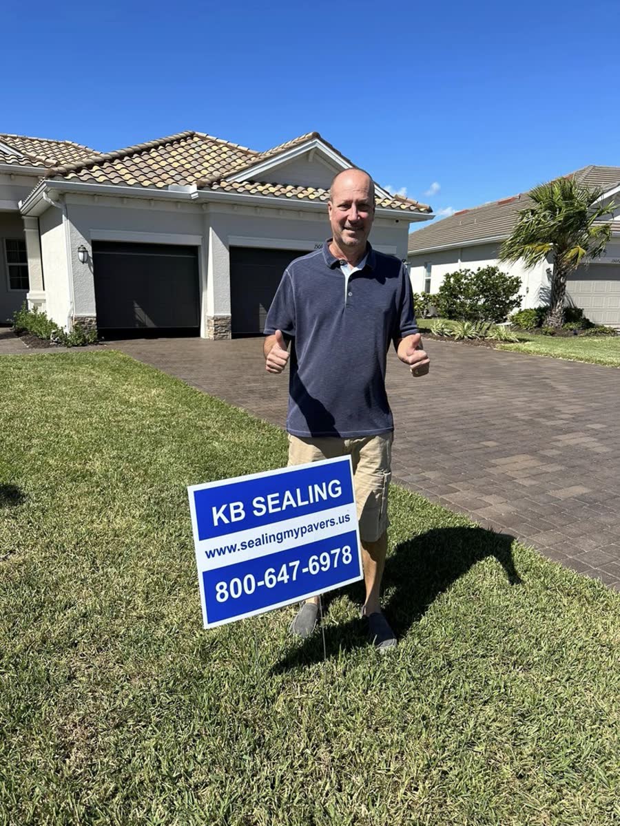 KB Sealing customer with the KB Sealing yard sign on his sealed driveway